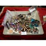 A box of costume jewellery including pendants, bracelets, necklaces etc.