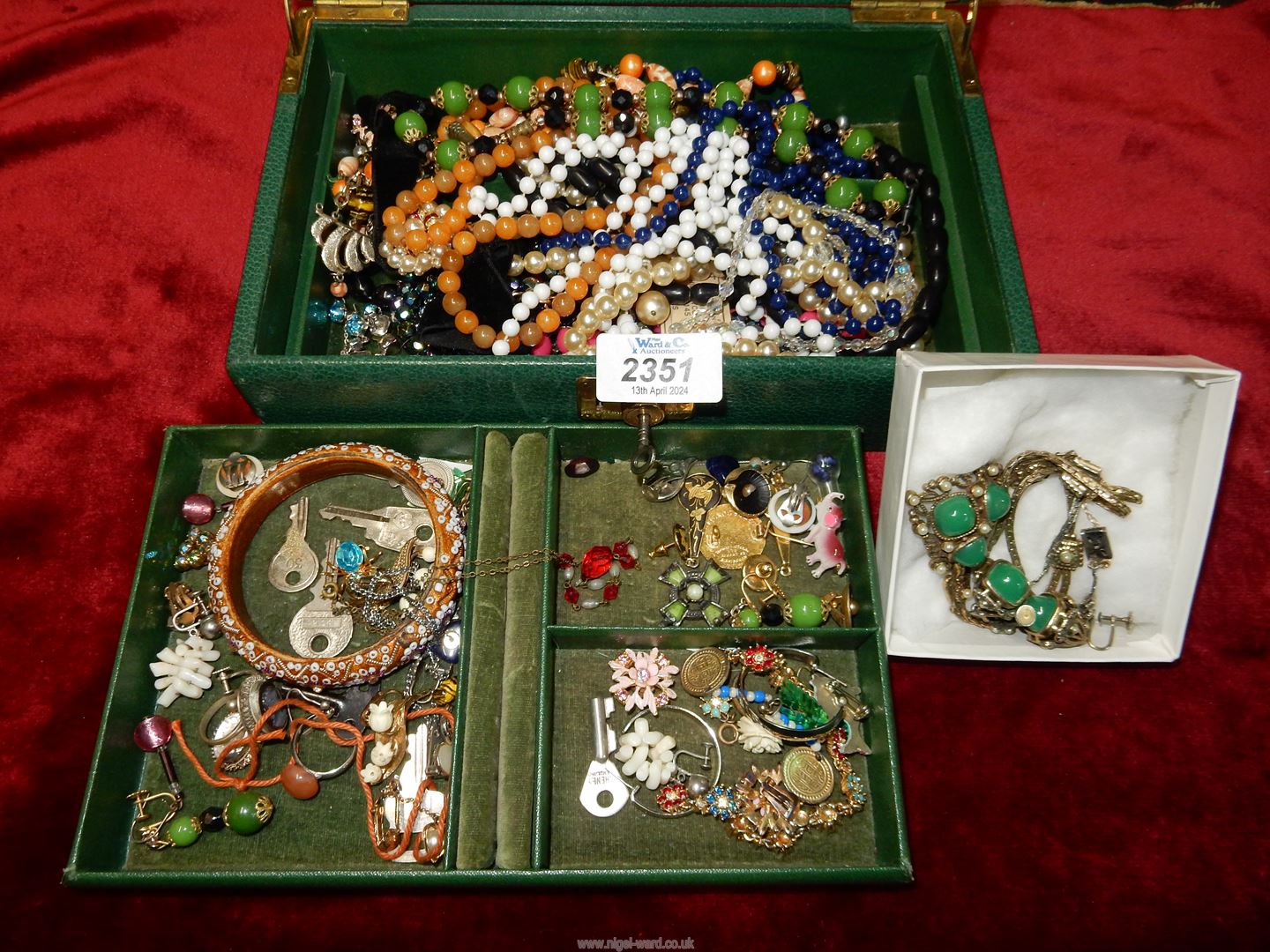 A green jewellery box and contents of bead necklaces, earrings etc.