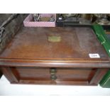 A large Oak canteen of cutlery with two drawers having brass escutcheon to the lid inscribed