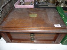 A large Oak canteen of cutlery with two drawers having brass escutcheon to the lid inscribed
