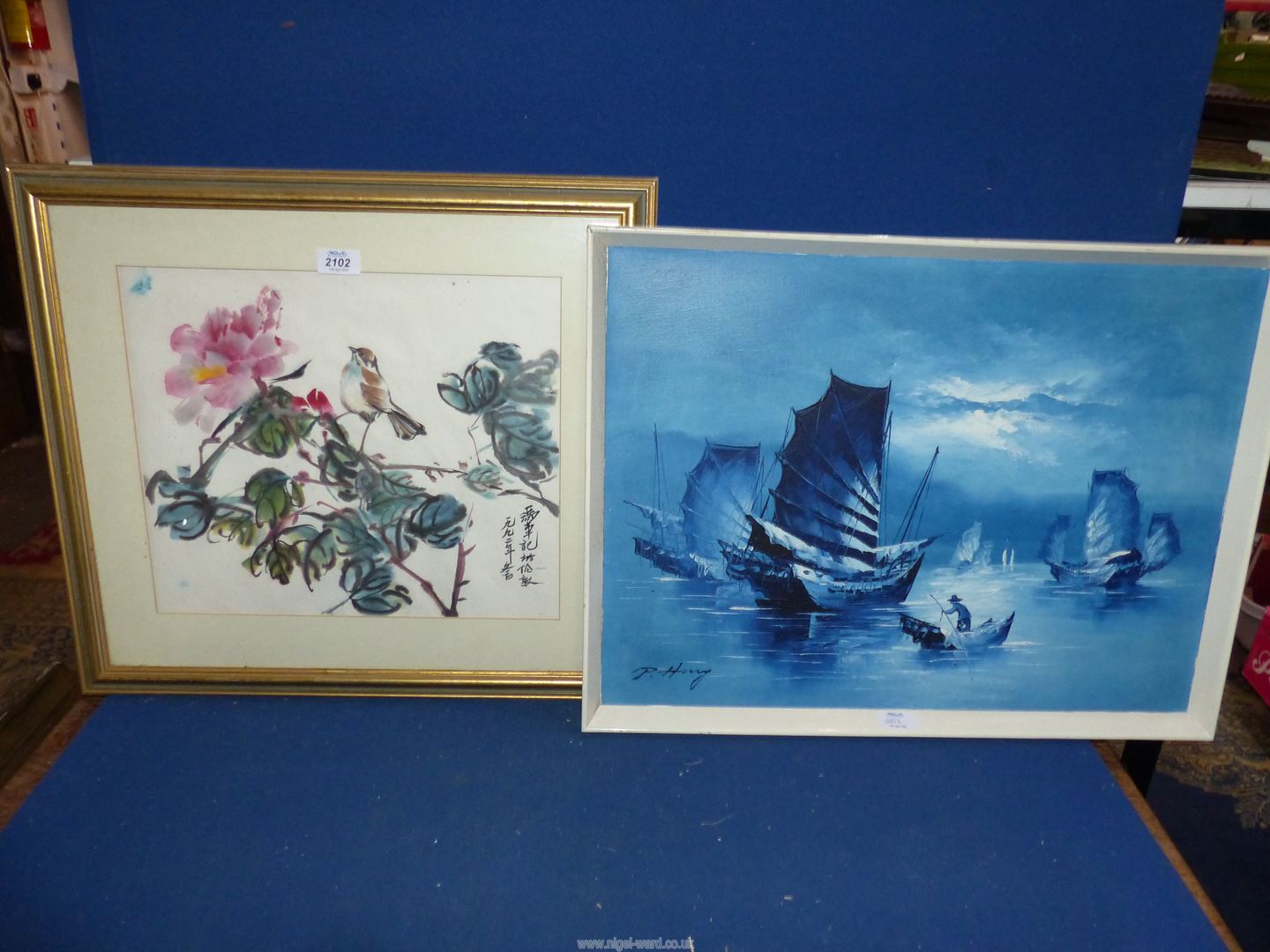 A white framed oriental Oil on board of Junk boats in blue tones, signed lower left,