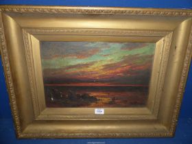 A heavy gilt framed Oil on canvas depicting Seascape at sunset, signed lower right R.C.