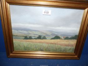 A framed E.J. Wilson painting, signed lower left, depicting The Brecon Beacons, 16 1/2" x 12 1/2".
