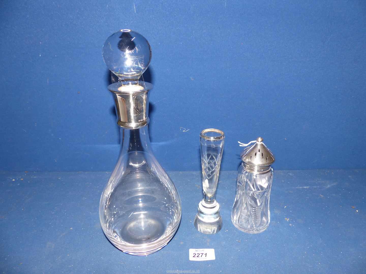 A glass slice cut, sugar Caster with London 1938 silver top,