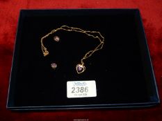 A 9ct gold chain with heart shaped pendant having purple stones,