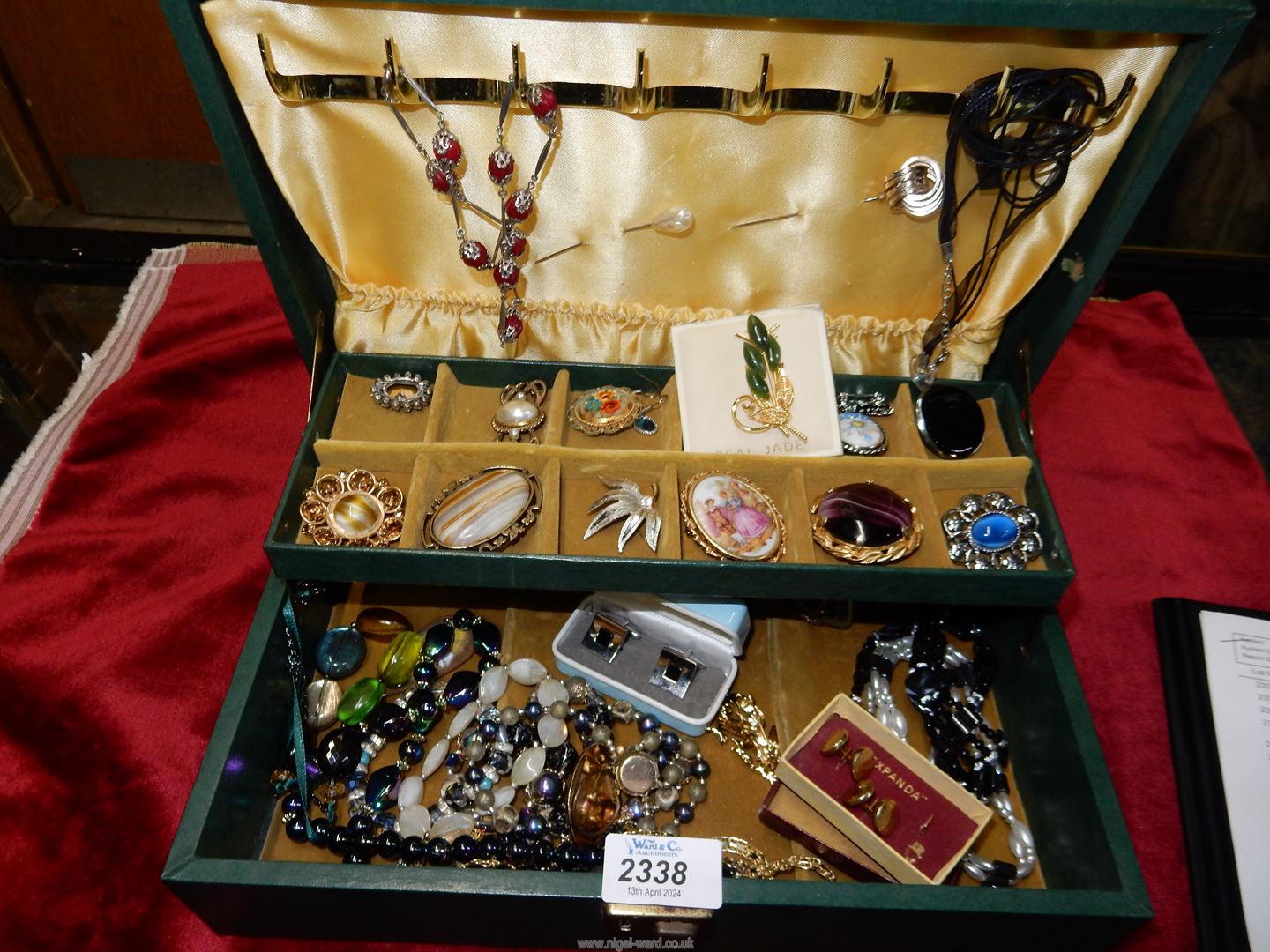 A box of costume jewellery in a green case.