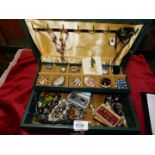 A box of costume jewellery in a green case.