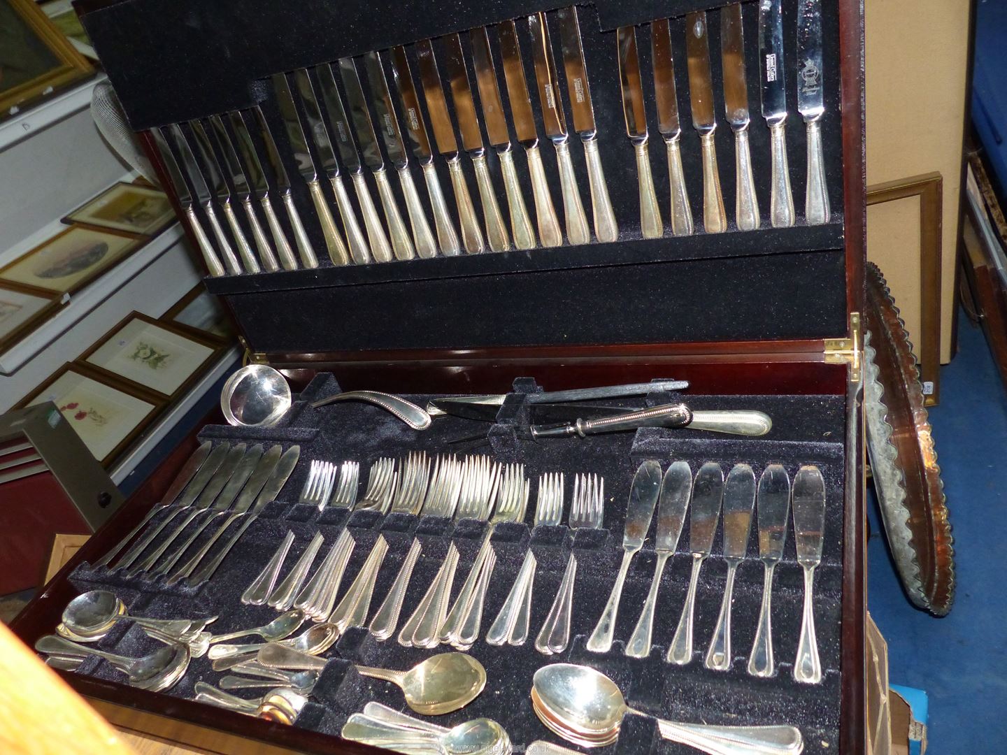 A large canteen with brown tooled leather top containing 12 place setting Sheffield EPNS cutlery,