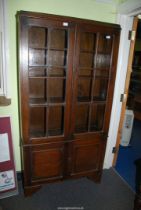 An Oak glazed bookshelf with lower cabinet, 3' wide x 70" high x 12" deep.