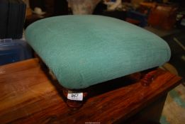 A low green footstool.