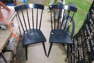 Two black stickback chairs.