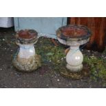 Two concrete bird baths.