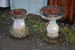 Two concrete bird baths.