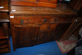An oak sideboard with two frieze drawers and cupboard under 48" x 18" x 27" high.