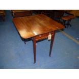 A Mahogany Pembroke table, standing on tapering square legs with brass castors, with drawer,