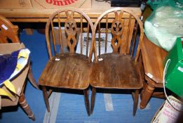 A pair of Country Oak stick back chairs