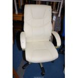 A cream coloured upholstered swivel office chair.