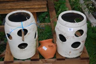 Two large and one small strawberry planters.