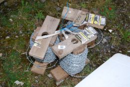 Three part rolls of barbed wire.