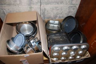 Cooking pans in two boxes, cake tins, bun tins etc.