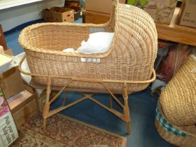 A wicker crib, linen and mattress.