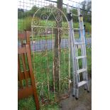 An arched wrought iron garden gate, 29" wide x 6' high.