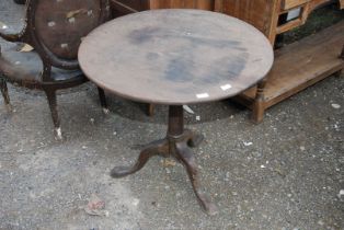 A circular Oak snap top table, 30" wide x 28" high.