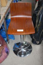 A chrome based adjustable bar stool.