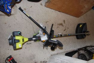 A Ryobi strimmer (as new) with brush cutter.