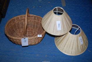 A wicker basket and two lampshades.