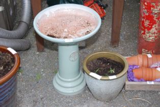 A glazed bird bath and a small glazed planter.