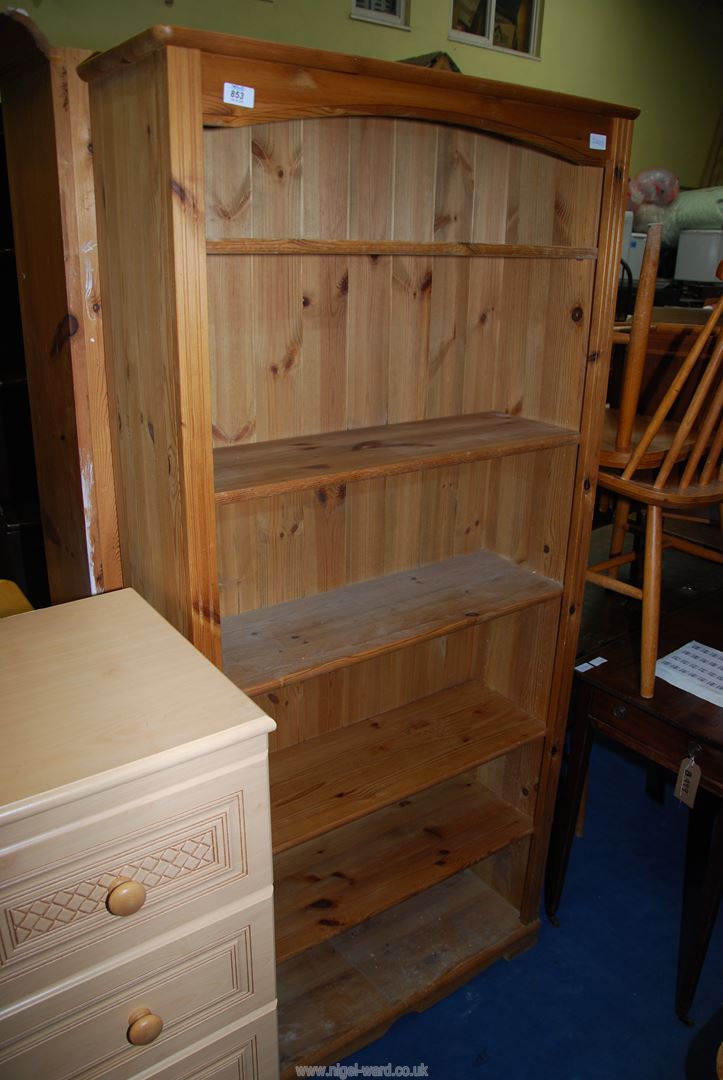 A pine shelf unit having six shelves, 32" wide x 11" deep x 69" high.
