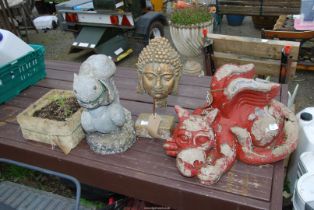 A fibreglass dragon, bust, squirrel and a concrete planter.