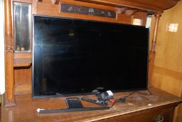 A Hitachi 50" 4k smart TV with remote (SOLD as SEEN - Faulty Screen).