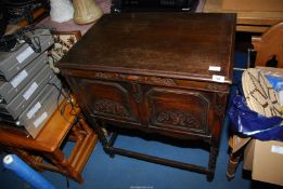 An old oak cased wind-up Gramophone with records.