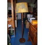 A wooden standard lamp with shade.