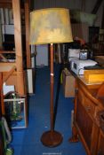 A wooden standard lamp with shade.