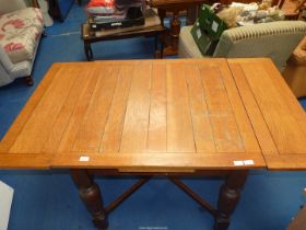 A drawleaf Oak Dining Table, 35 1/2'' x 35 1/2'' extending to 58 1/2'' x 30'' high.