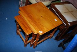 A nest of three pine tables.