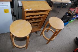 A pine wine rack (16 bottles) and two bar stools.