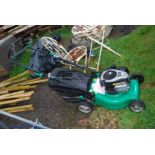 A garden line petrol lawn mower with grass box.