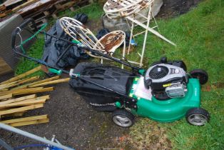 A garden line petrol lawn mower with grass box.