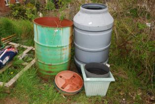 A plastic water butt, a metal drum 205 litre, plastic planters etc.