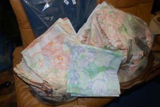 A quantity of curtains and curtain fabric, floral pastel marked Tricia Guild.