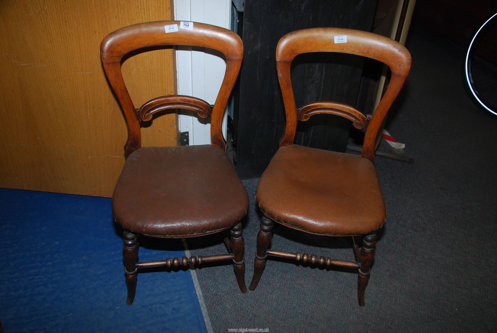 A pair of Rexine seated Mahogany side chairs.
