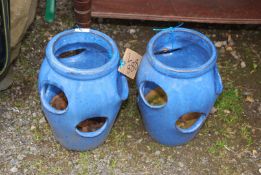 A pair of glazed strawberry planters.