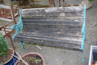 A garden bench with cast iron back and sides, 50" wide x 27" high.