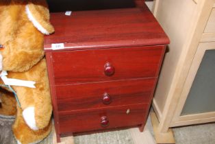 A mahogany finished bedside chest of three drawers.