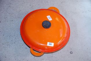 An orange Le Crueset casserole pot and lid.
