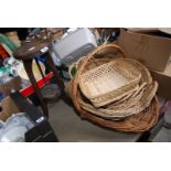 A quantity of wicker trays and plant stand.